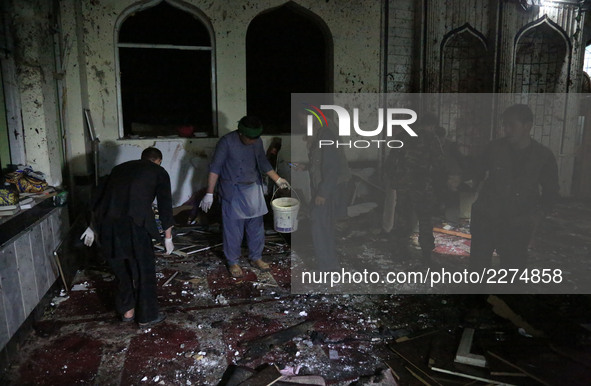 People inspect the site of an attack at a Shiite mosque named Imam-e-Zaman in Dasht-e-Barchi locality in Kabul, capital of Afghanistan, on O...