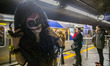 A girl with makeup and costumes of the Mexican character La Catrina is seen traveling on t...