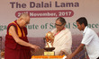 Tibetan spiritual leader Dalai Lama looks at the KIIT Deemed University as he receives KIS...