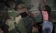 Zimbabweans drink, sing, and dance as they celebrate at night at an intersection in downto...