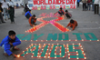 Indian Children light candles during an HIV/AIDS awareness campaign on the occasion of Wor...