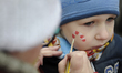 A child gets a face painting during a charity event on December 3, 2017. For the tenth yea...