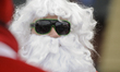 Motorcycle riders dressed in Santa Claus costumes are seen on December 3, 2017. For the te...