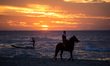 A palestinian man rides his horse during sunset on the beach of Gaza City, December 11, 20...