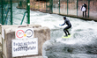 A surfer on the Eisbach	(Ice Stream) in the English garden on December 12th, 2017 in Munic...