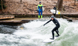 A surfer on the Eisbach	(Ice Stream) in the English garden on December 12th, 2017 in Munic...