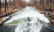 A surfer on the Eisbach	(Ice Stream) in the English garden on December 12th, 2017 in Munic...