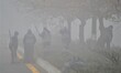 Municipality workers are seen next to a foggy road on the heavy mist in Ankara, Turkey on...