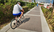 Caorle, Veneto, Italy . May 2014,  Man rides on the bike along the promenade at the Adriat...
