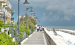 Caorle, Veneto, Italy . May 2014,  People walks along the promenade at the Adriatic sea co...