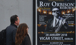 A couple passes in front of Roy Orbison 20th anniversary tribute concert add, in Dublin's...