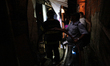 A rman helps firefighters that are containing a major fire that hit a slum located in the...