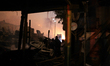 Residents observe while firefighters managed to contain a major fire that hit a slum locat...