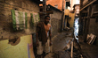 A man stands after a manjor fire hit a slum located in the Campo Belo neighborhood on the...