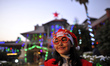A Portrait of Eva George, 11rs old, poses for the photo with the Christmas hat on her head...