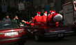 Men  dressed as a Santa Claus parade on a old car on the last day of 2017 in Gaza city, Pa...