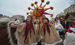 A group of young girls takes a selfie with their Christmas Star in front of Lviv's Opera a...