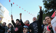 People chant slogans and raise their arms as they took part in the celebration of the 7th...