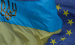 A view of EU and Ukrainian flags, coat of arms and symbols, seen in Lviv's city center. O...