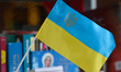 A view of an Ukrainian flags with a coat of arms, seen in Lviv's city center. On Monday,...