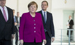 German Chancellor Angela Merkel (C) arrives to a presentation of new 2 Euro coins with ima...