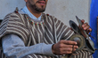 Man clangs cymbals while accompanying musicians singing traditional songs in the medina (o...