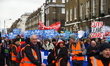 People march holding placards and standards, to protest sgainst the crisis of the state-ru...