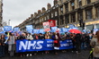 People march holding placards and standards, to protest sgainst the crisis of the state-ru...