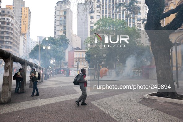 Riot police fire tear gas in an attempt to disperse people after an eviction ended in violent clashes in downtown Sao Paulo, Brazil on Septe...