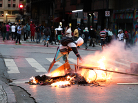 A protester sets fire to rubbish and scrap wood in the middle of the street after an eviction ended in violent clashes in downtown Sao Paulo...