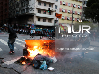 People set fire to rubbish and scrap wood in the middle of the street after an eviction ended in violent clashes in downtown Sao Paulo, Braz...