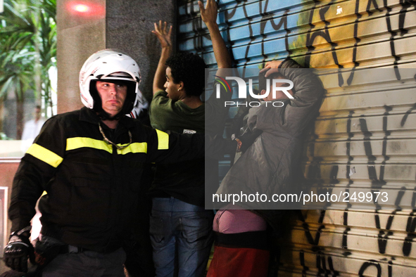 Firefighters arrest two young men after an eviction ended in violent clashes in downtown Sao Paulo, Brazil on September 16, 2014. The evicti...
