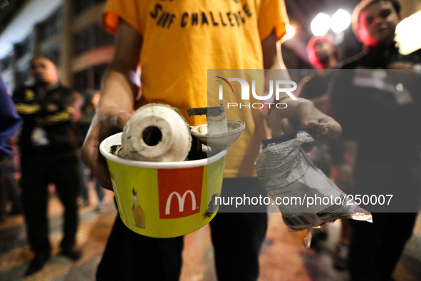 A man holds a pot containing remains of bombs used by the police after an eviction ended in violent clashes in downtown Sao Paulo, Brazil on...