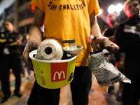 A man holds a pot containing remains of bombs used by the police after an eviction ended in violent clashes in downtown Sao Paulo, Brazil on...