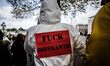 Protester wearing placard with slogans. Marches and rallies against seed giant Monsanto we...