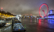 London Eye illuminated in red light, a giant Ferris over Thames River in London, UK on 19...