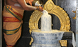 Tamil Hindu priest performs special prayers by pouring milk over a Shiva Lingam during the...