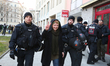 An activist shows the peace sign while she gets arrested, in Munich, Germany, on March 20,...