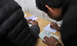Nepalese Youths filling the pay slip of the amount for the application submission for the...