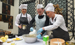 Staff members of the 'Pod Aniolami' restaurant during baking demonstration of a traditiona...