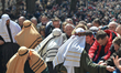 Volunteers carry a security cord, a scene from a reenactment of the Way of the Cross in Ka...