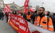 Employees of the French state owned railway company SNCF wearing union jackets and holding...