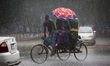 People on street during sudden rain in Dhaka, Bangladesh on April 17, 2018. 