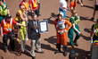 Runners receive a Guinness Record Certificate during the Virgin Money London Marathon in L...