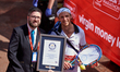 Runners dressed in fancy costumes receive a Guinness Record Certificate during the Virgin...