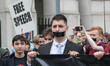 Protester covers mouth with black tape as an action to call for free speech in London, on...