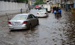 Vehicles and Rickshaws try driving with passengers through the waterlogged streets of Dhak...