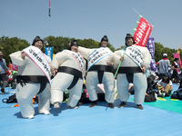 Workers wears a sumo costume during the May Day rally sponsored by the Japanese Trade Union Confederation, known as Rengo at Yoyogi Park in...