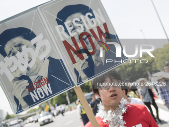 Worker holds placard during the May Day rally sponsored by the Japanese Trade Union Confederation, known as Rengo at Yoyogi Park in Shibuya...