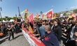Railway workers and supporters take part in a gathering of employees of the state-owned ra...